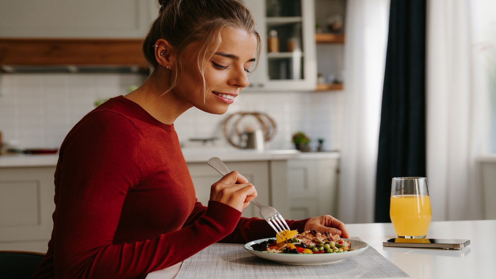 woman eating healthy meal from small plate.