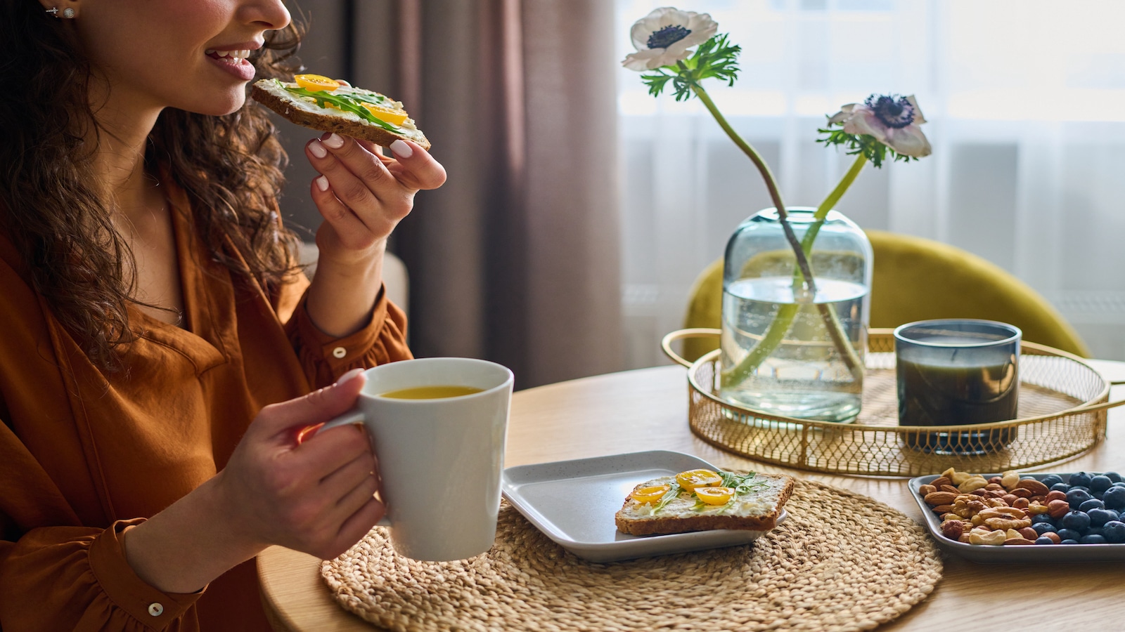 woman eating sandwich on whole wheat bread.
