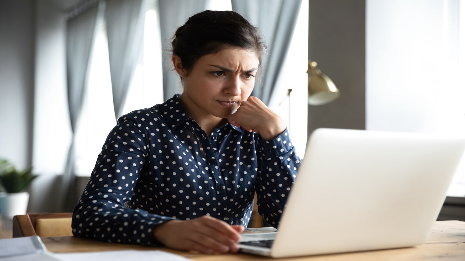 woman concerned frustrated looking at computer.
