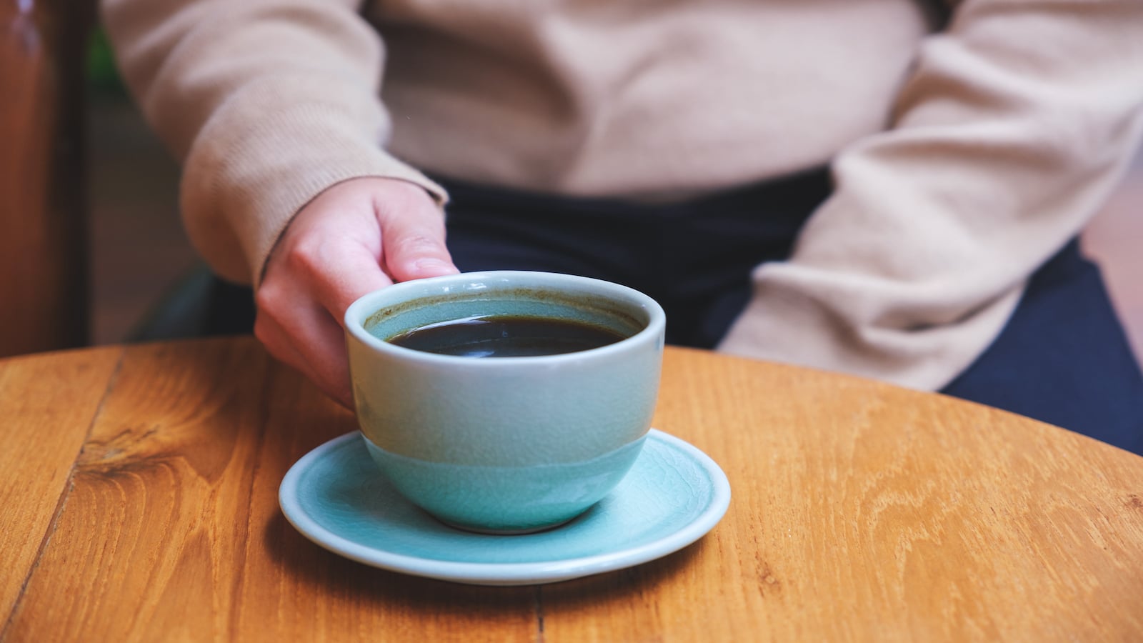 woman holding cup of coffee