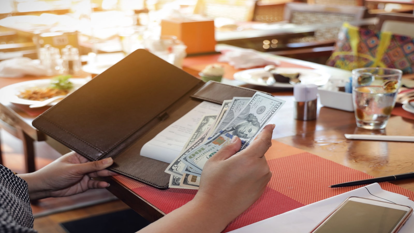 woman paying bill in cash.