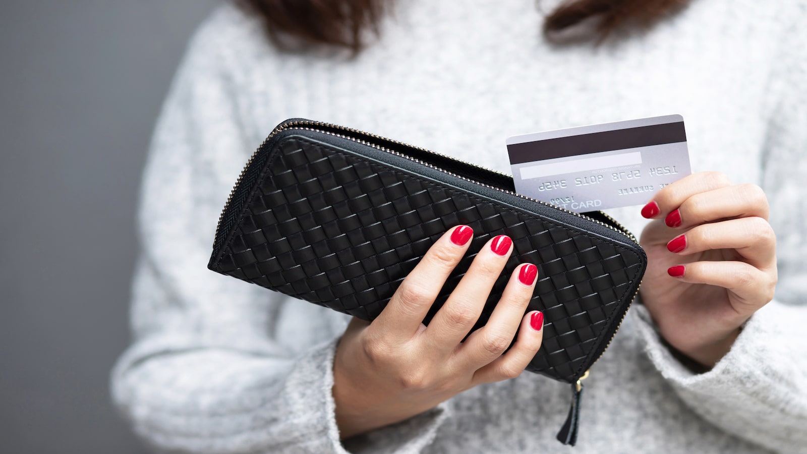 woman putting credit card away.