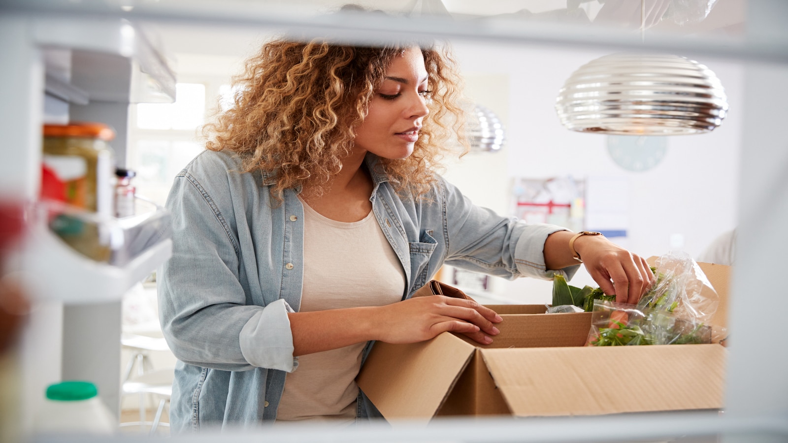 woman putting groceries away.