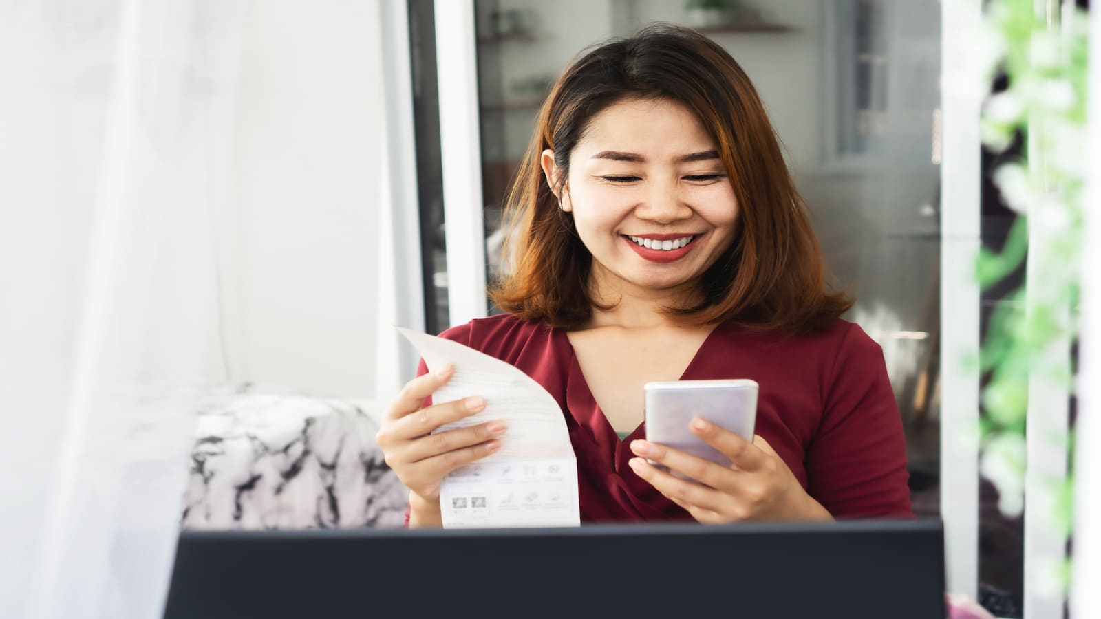 woman scanning receipt with smart phone.