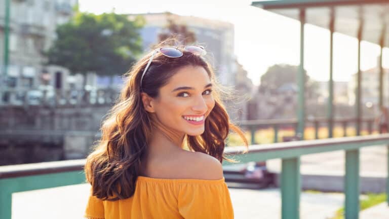 Woman smiling in street.