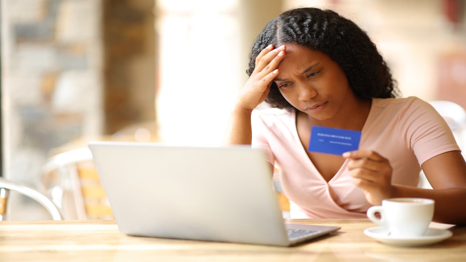 woman stressed using credit card online.