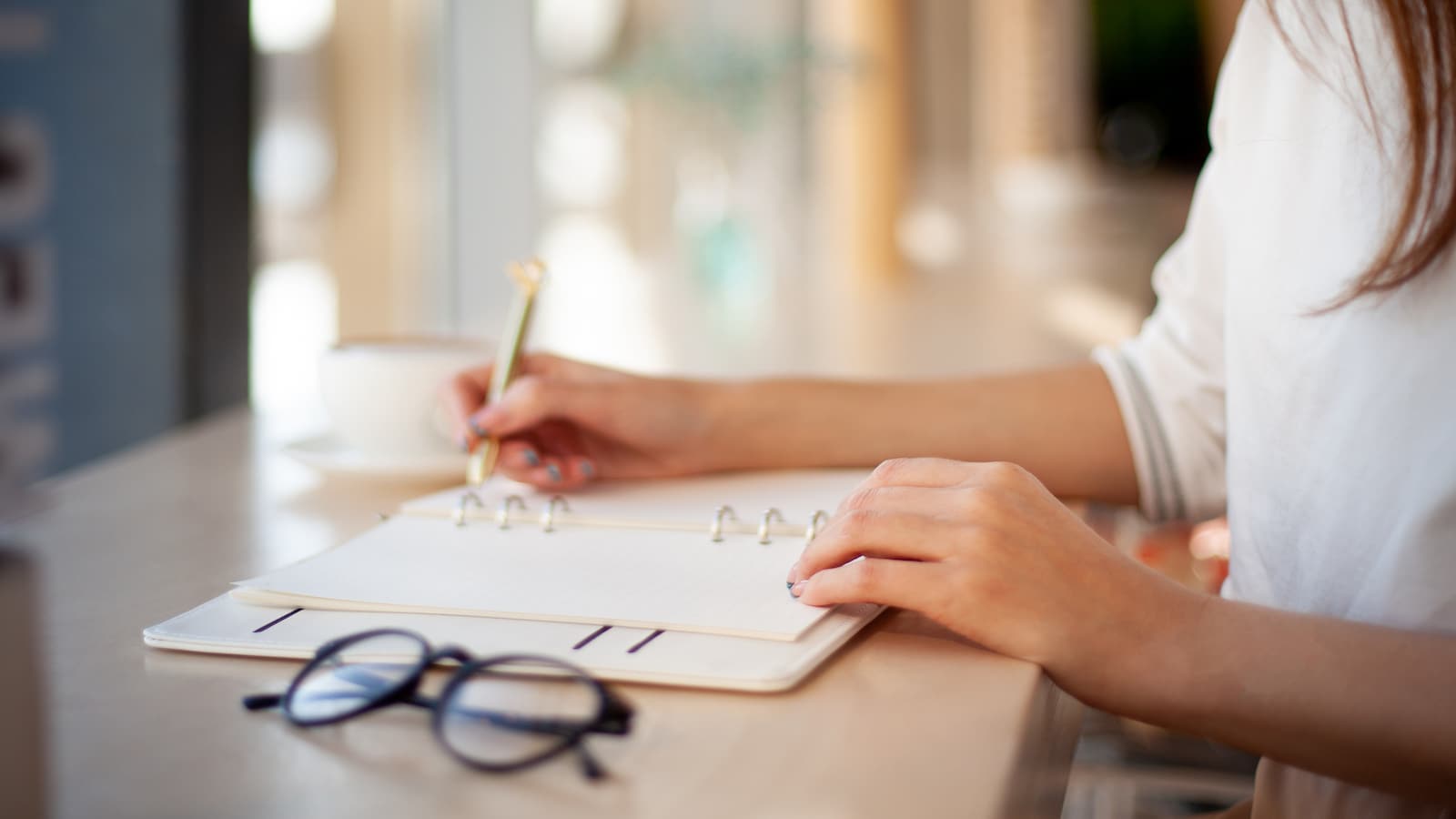 woman writing in planner.