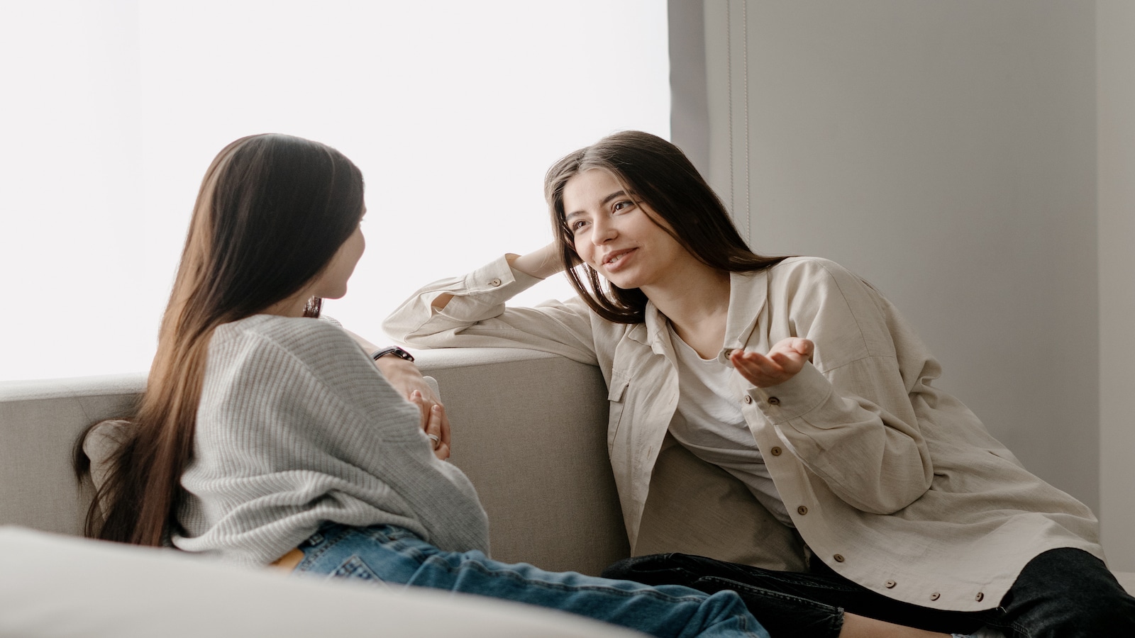 women talking on couch.