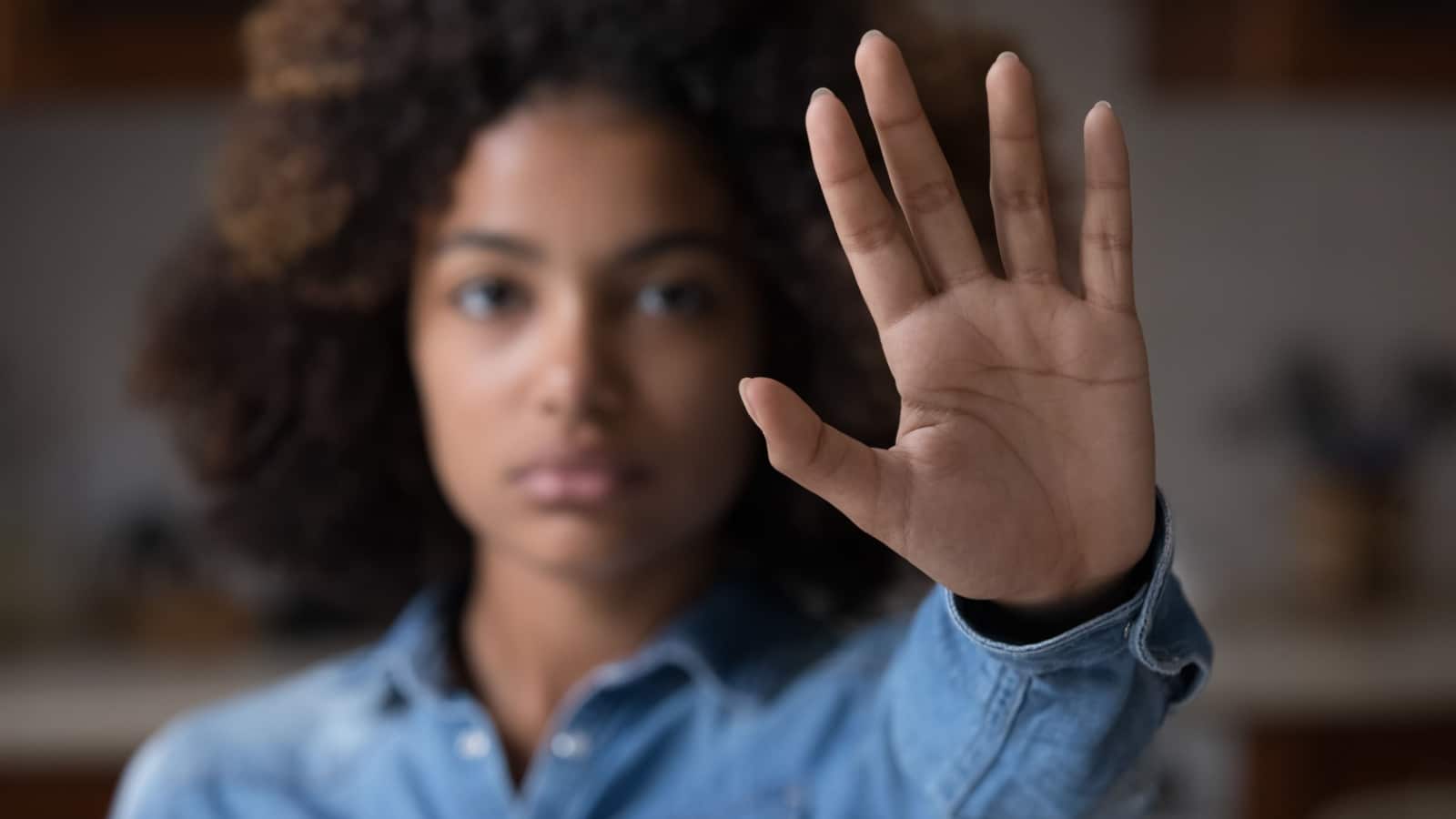 Close up focus African woman show palm hand opposes racial or gender discrimination.