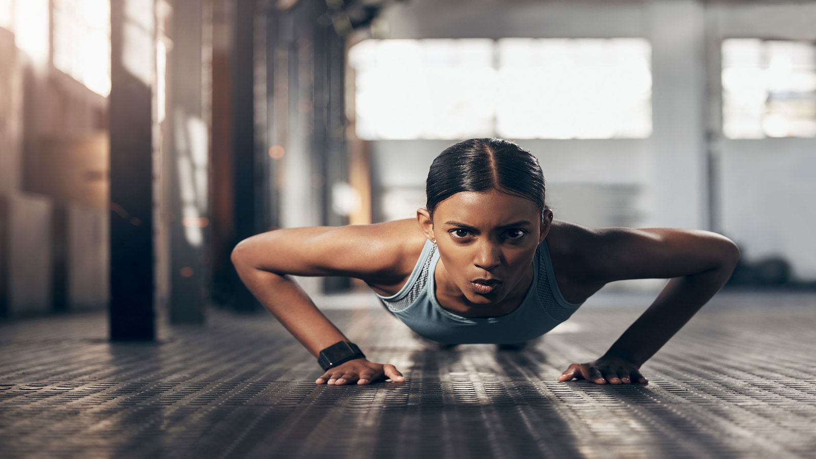 Woman doing pushup in gym extreme exercise.