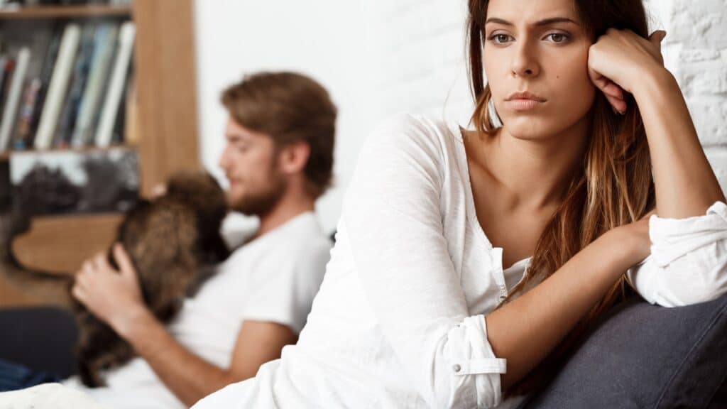 Dissapointed unhappy beautiful woman with her boyfriend background.