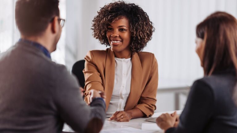 Woman shaking hands at job interview, meeting, business, office