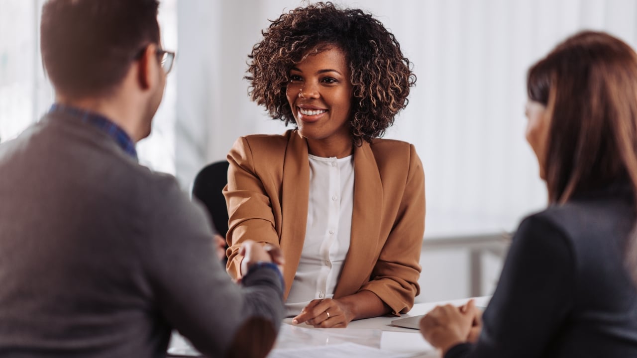 Woman shaking hands at job interview, meeting, business, office