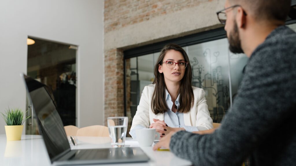 Woman and man talking at work.