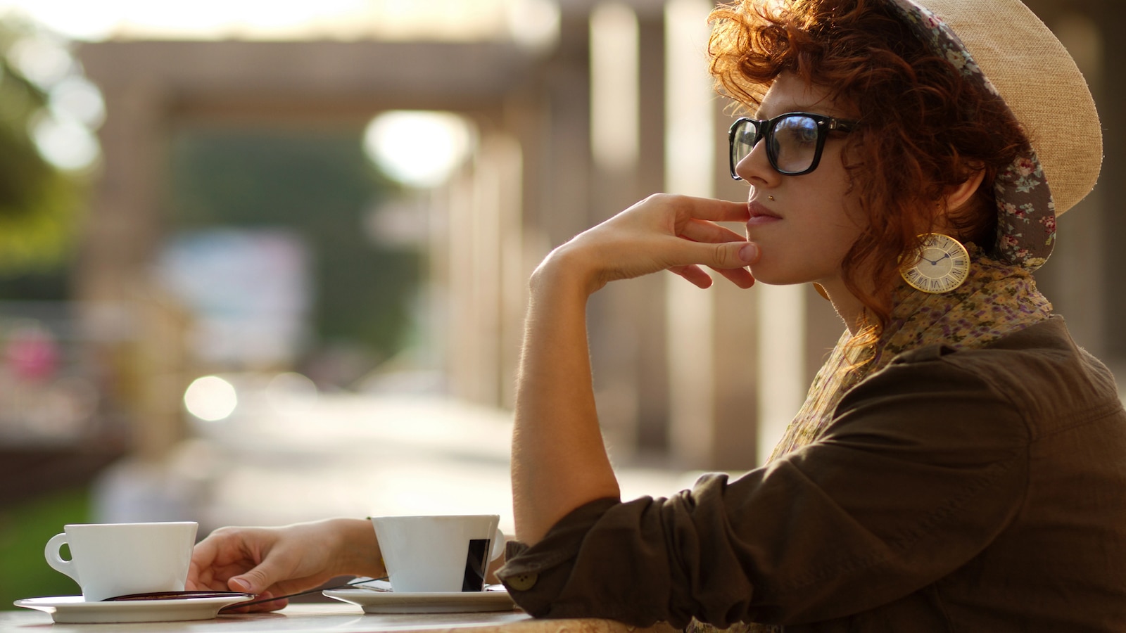 Young woman concentrating thinking in coffee shop