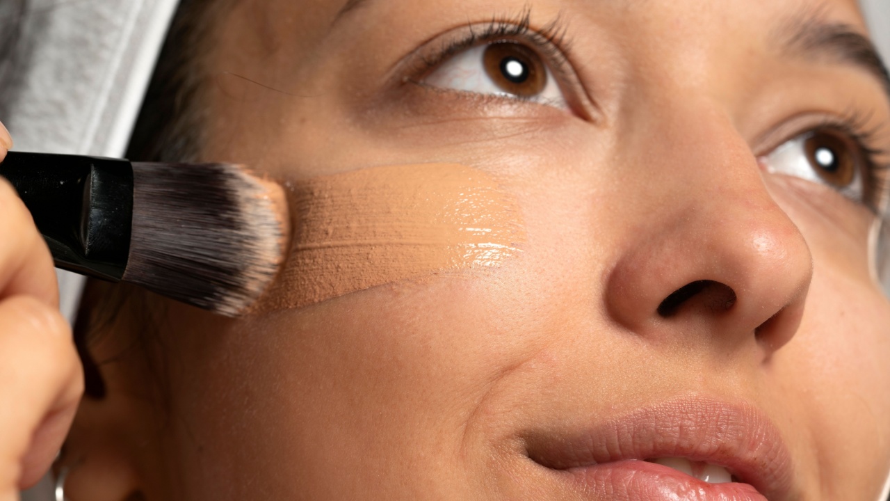 woman applying foundation to her cheek