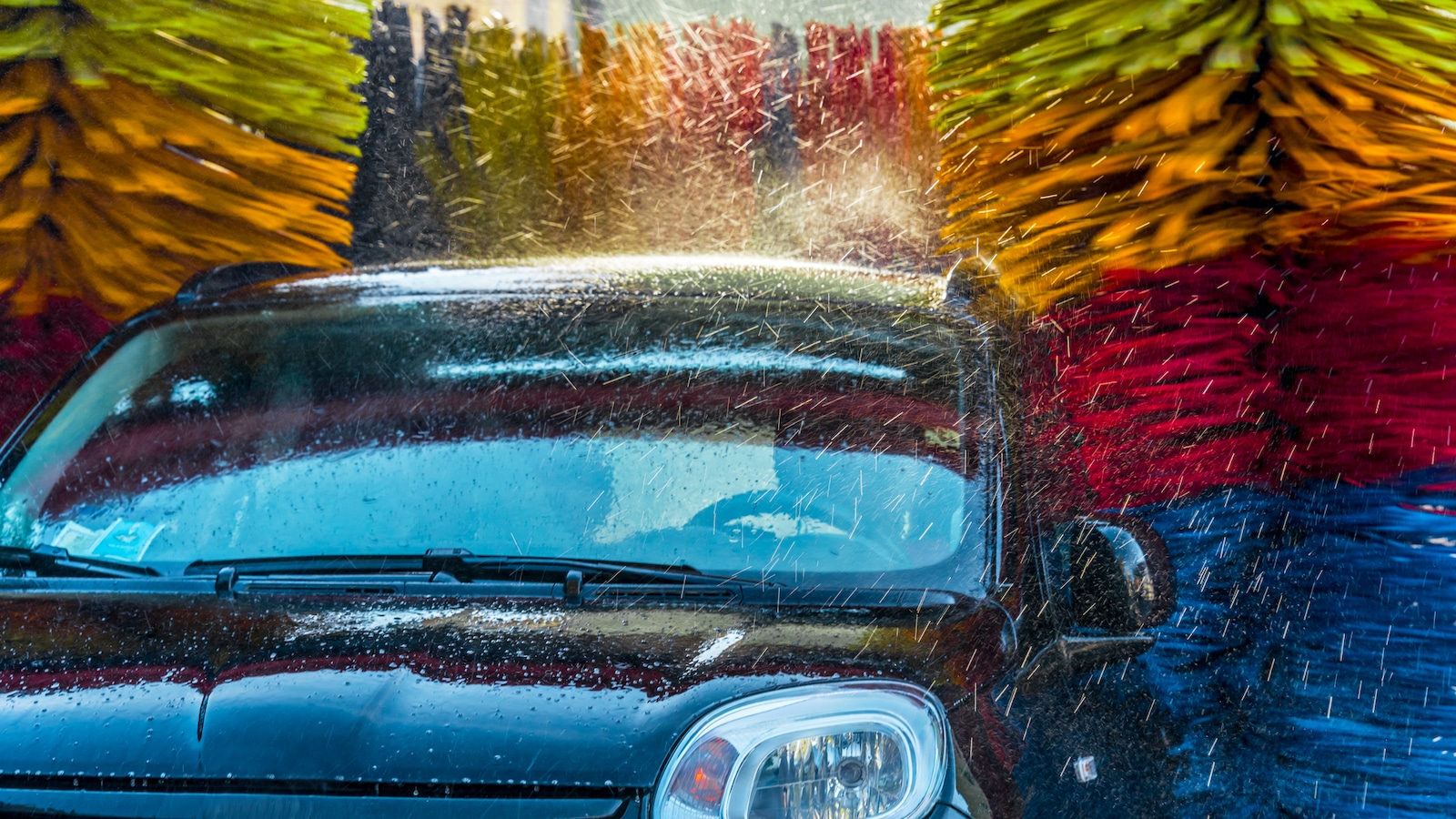 Car going through an automated car wash machine.