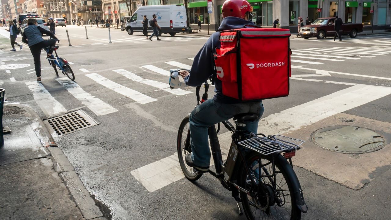 New York NY/USA-March 13, 2020 A delivery person with a DoorDash branded tote on his bicycle in the Chelsea neighborhood of New York