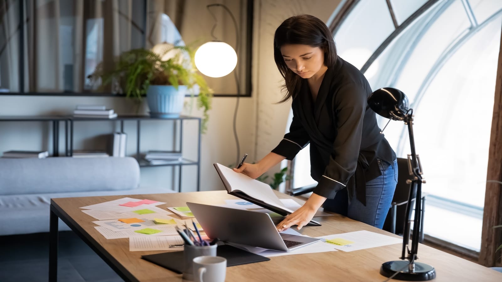 business woman finishing work organizing desk.