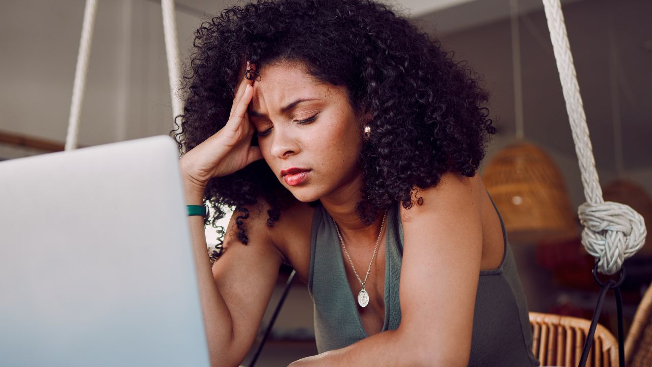 Stress, student and black woman with laptop in cafe frustrated from studying, working and project. University, burnout and stressed girl in coffee shop tired from learning on computer and books