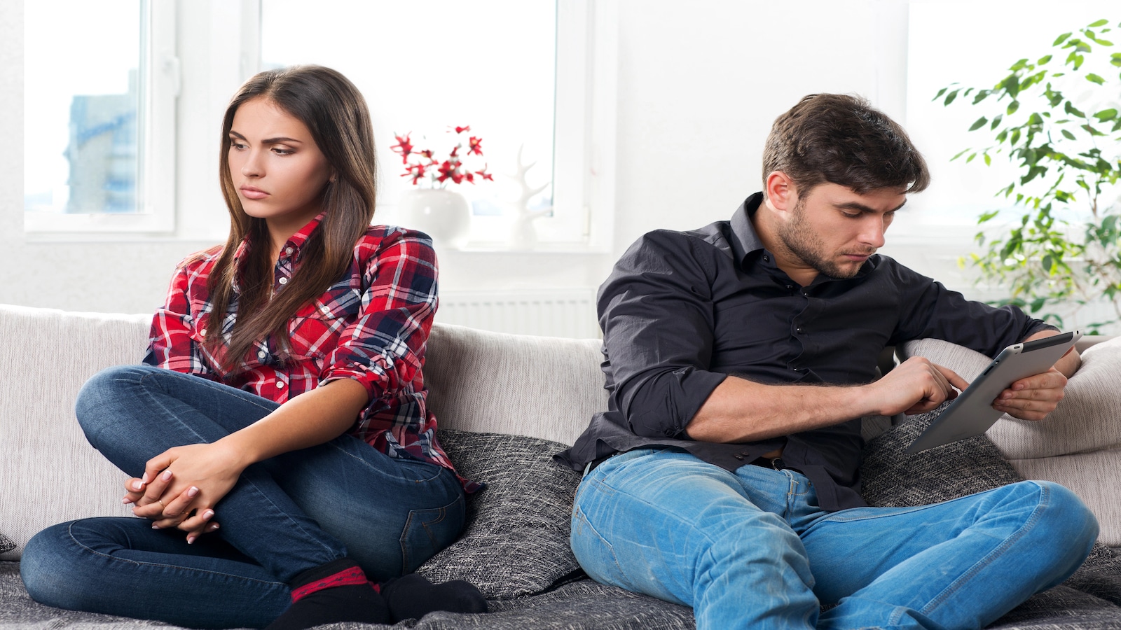 Uninterested couple not paying attention to each other.