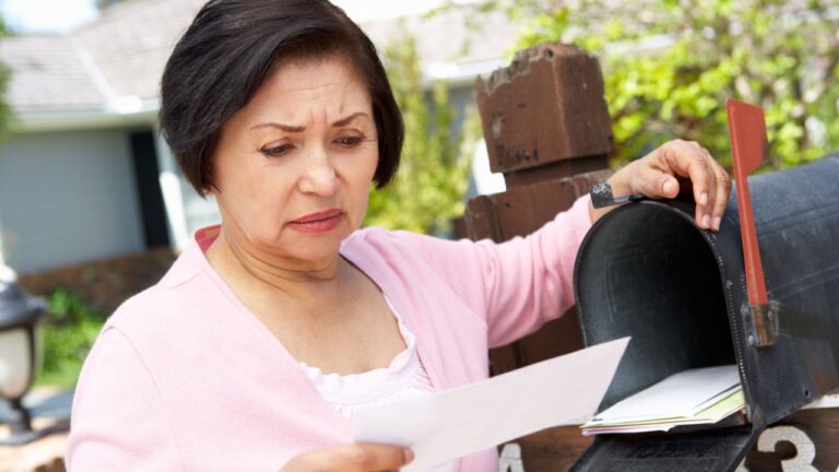 woman with debt checking the mail