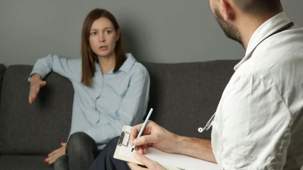 Depressed woman during psychotherapy. Young woman talking to her therapist. Anxiety or mental health therapy, marriage, family and carieer counseling.