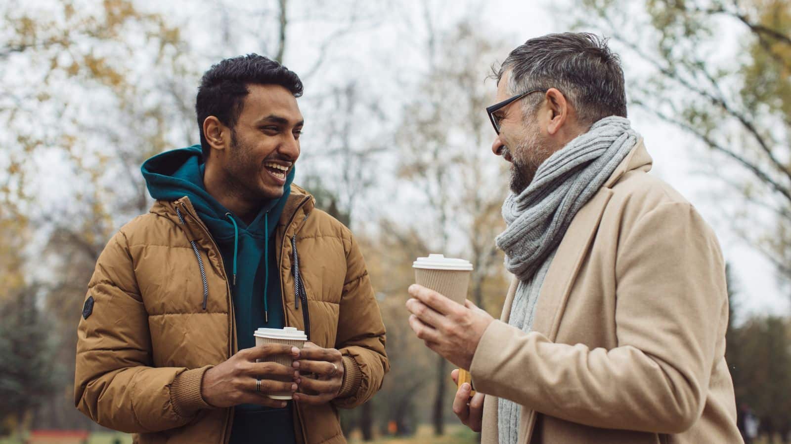Two friends talking and drinking coffee together.