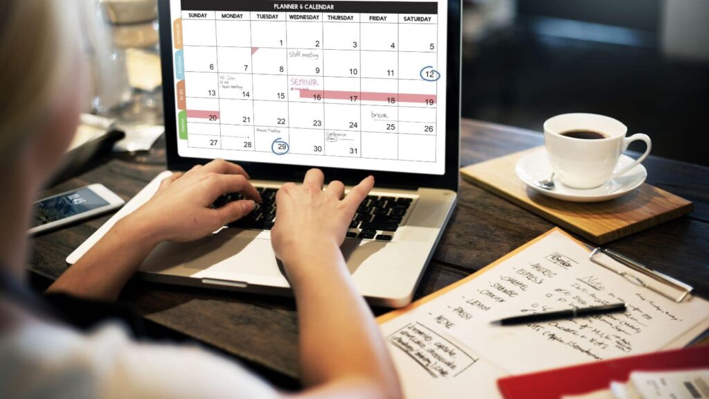 Woman-creating-a-plan-on-her-digital-calendar.