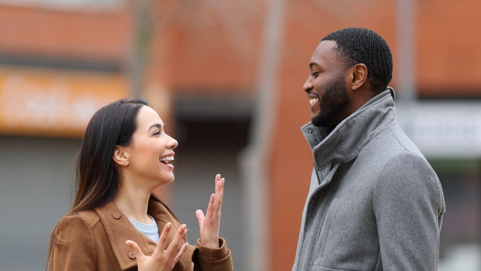 Young man actively listening to a woman talking.
