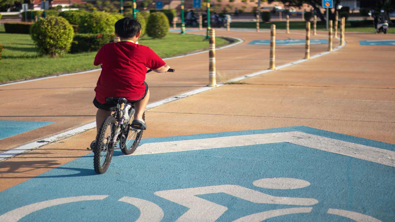 boy riding bike no helmet