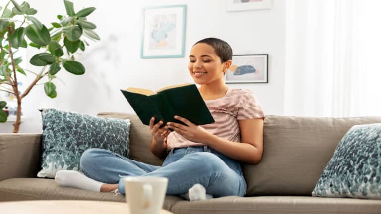 Woman reading book at home