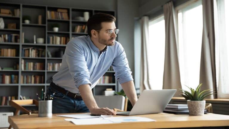 Man in office working thinking at computer.