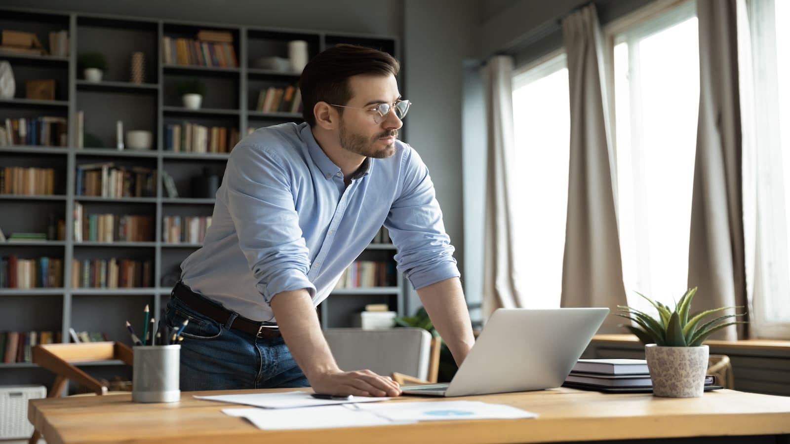 Man in office working thinking at computer.