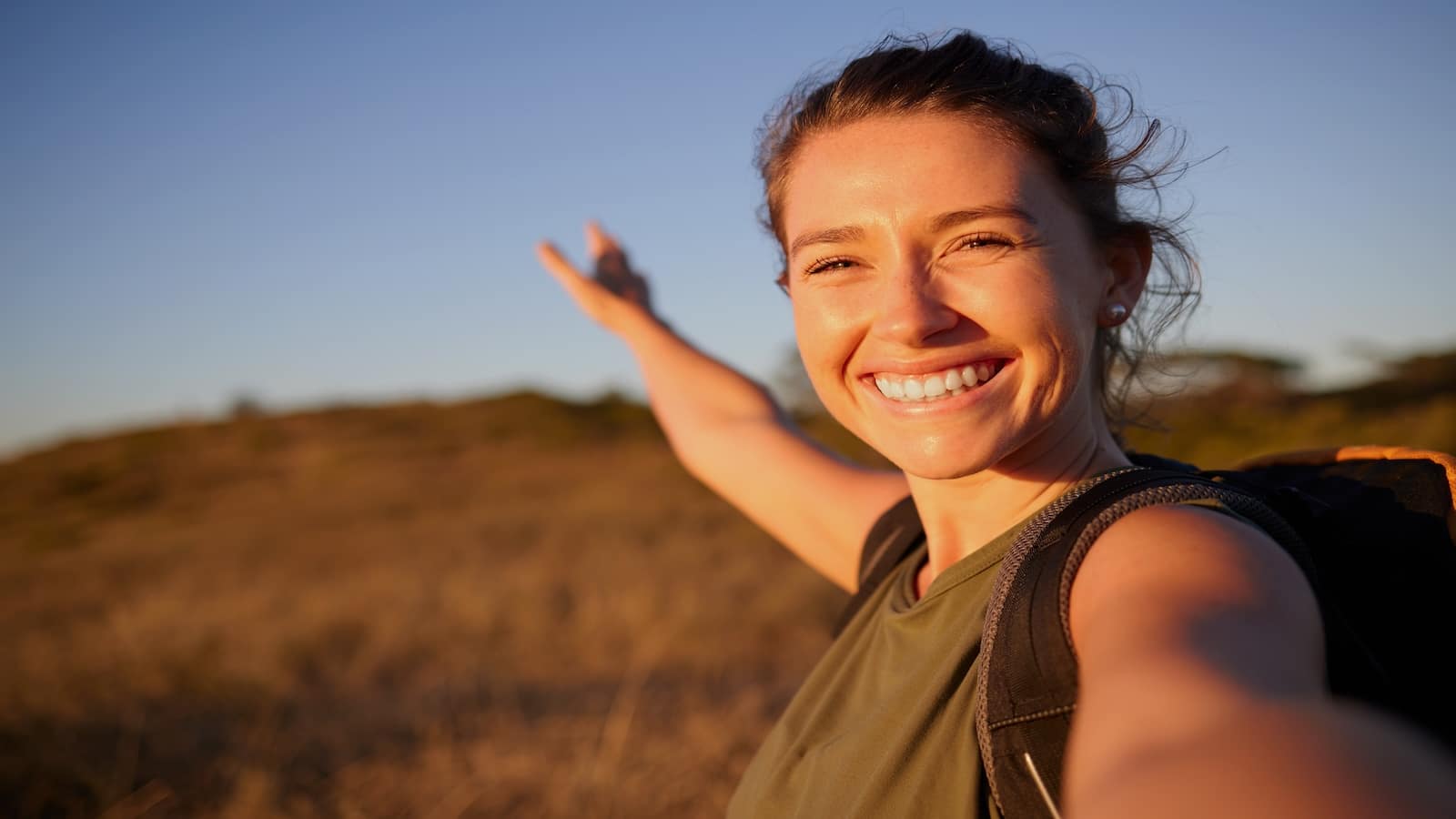 Young woman taking a selfie while out hiking/walking.