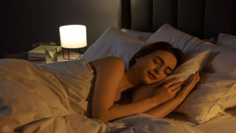 Beautiful young woman sleeping in bed at night.