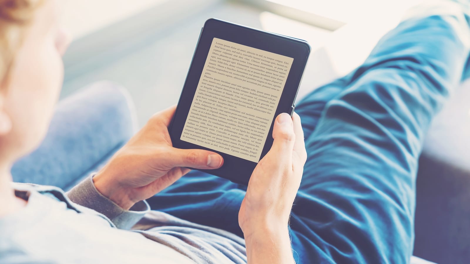 Man reading an e-book on digital tablet device e-reader.