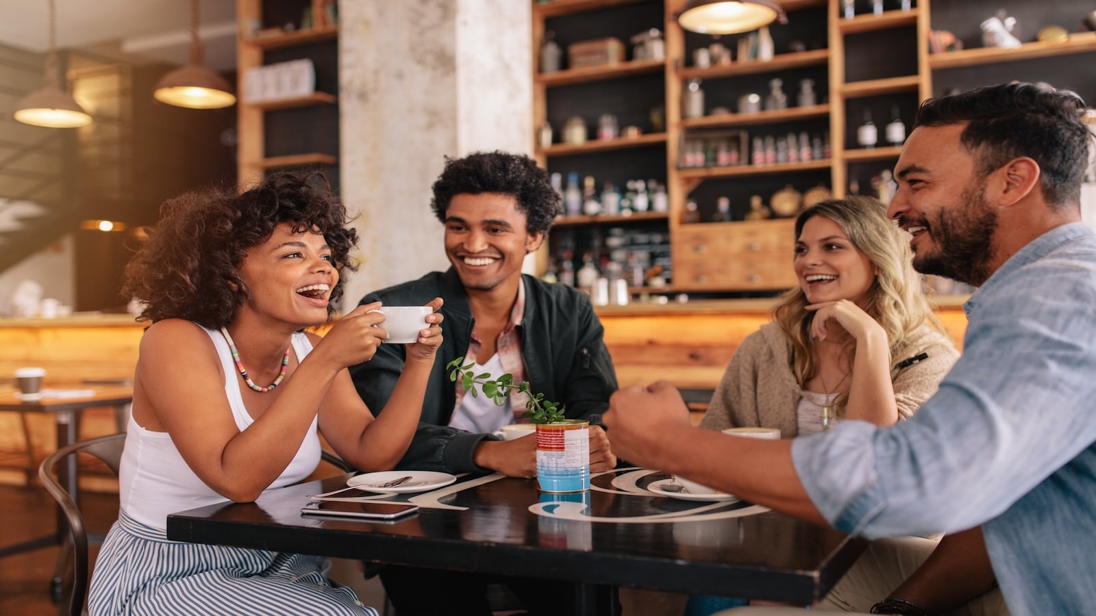 friends having lunch talking in restaurant or cafe.
