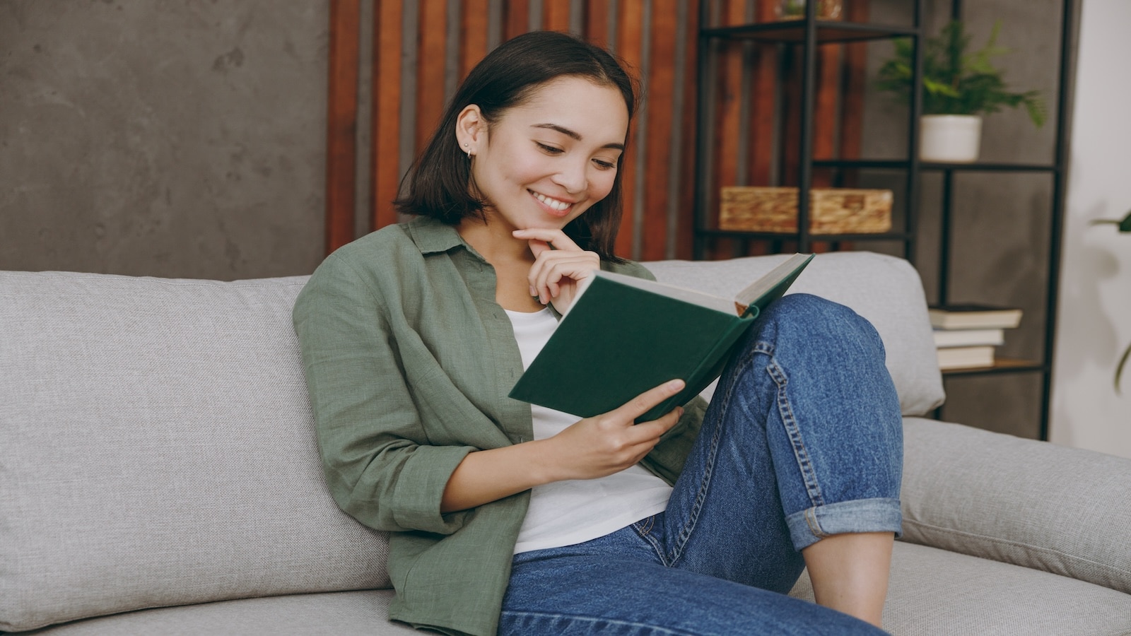 young woman smiling reading book.