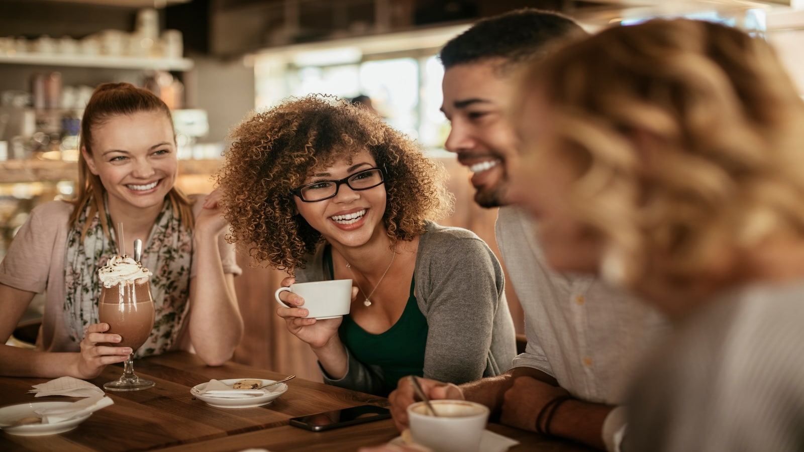 Group of young people enjoying a coffee in a cafe.
