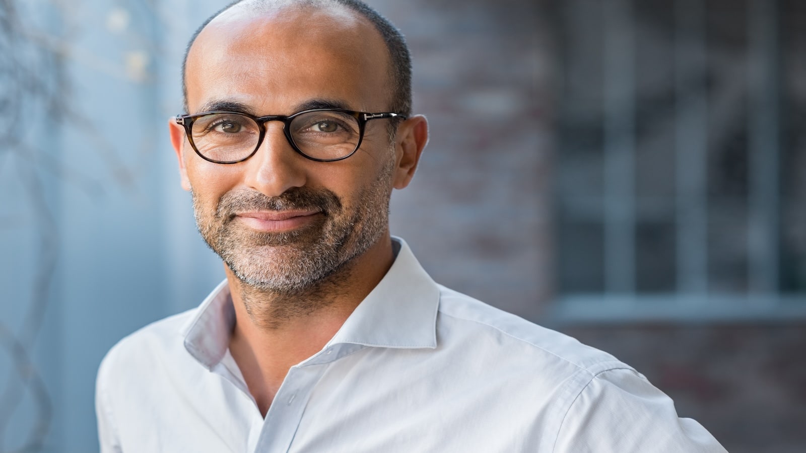 man in glasses smiling.