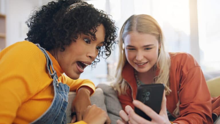 surprised friends looking phone