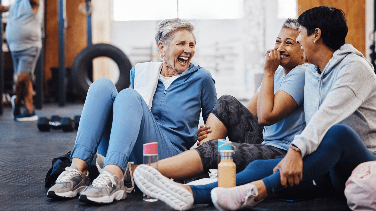 A group of women telling joke after fitness class, laughing together.