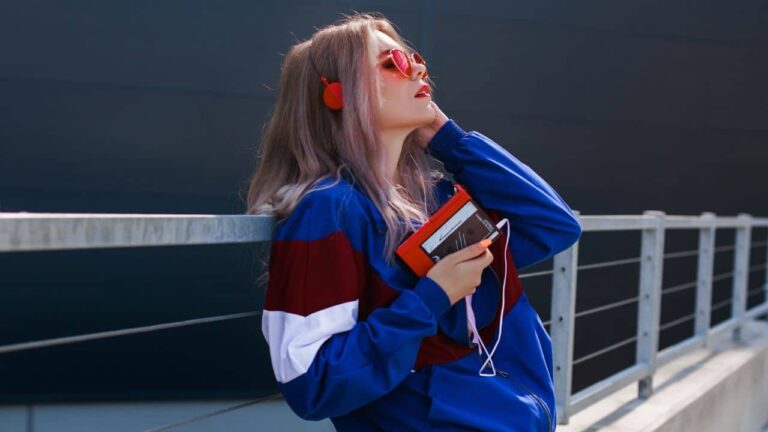 modern retro style 90s, girl in a blue sports jacket, cassette player, listening to music, urban style mood