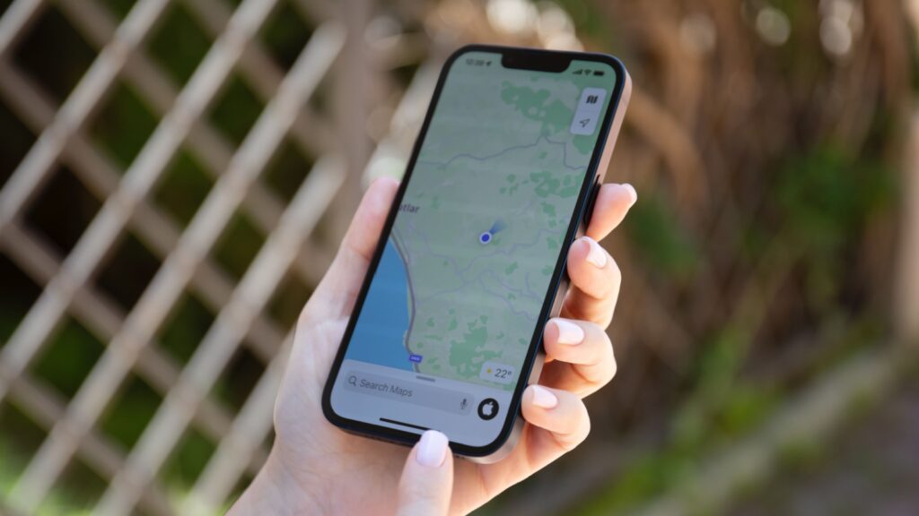 Alanya, Turkey - May 9, 2022: Man hands holding Apple iPhone 14 with Apple Maps on the screen. iPhone, Apple Maps and Car Play was created and developed by the Apple inc.