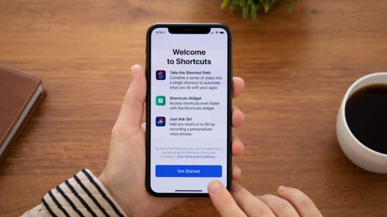 Alushta, Russia - September 26, 2018_ Woman hand holding iPhone X with home screen Shortcuts app. iPhone 10 was created and developed by the Apple inc.