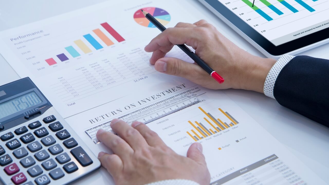 Businessman is deeply reviewing a financial report for a return on investment or investment risk analysis