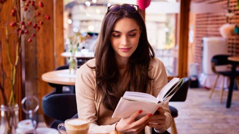 beautiful woman reading book in cafe.