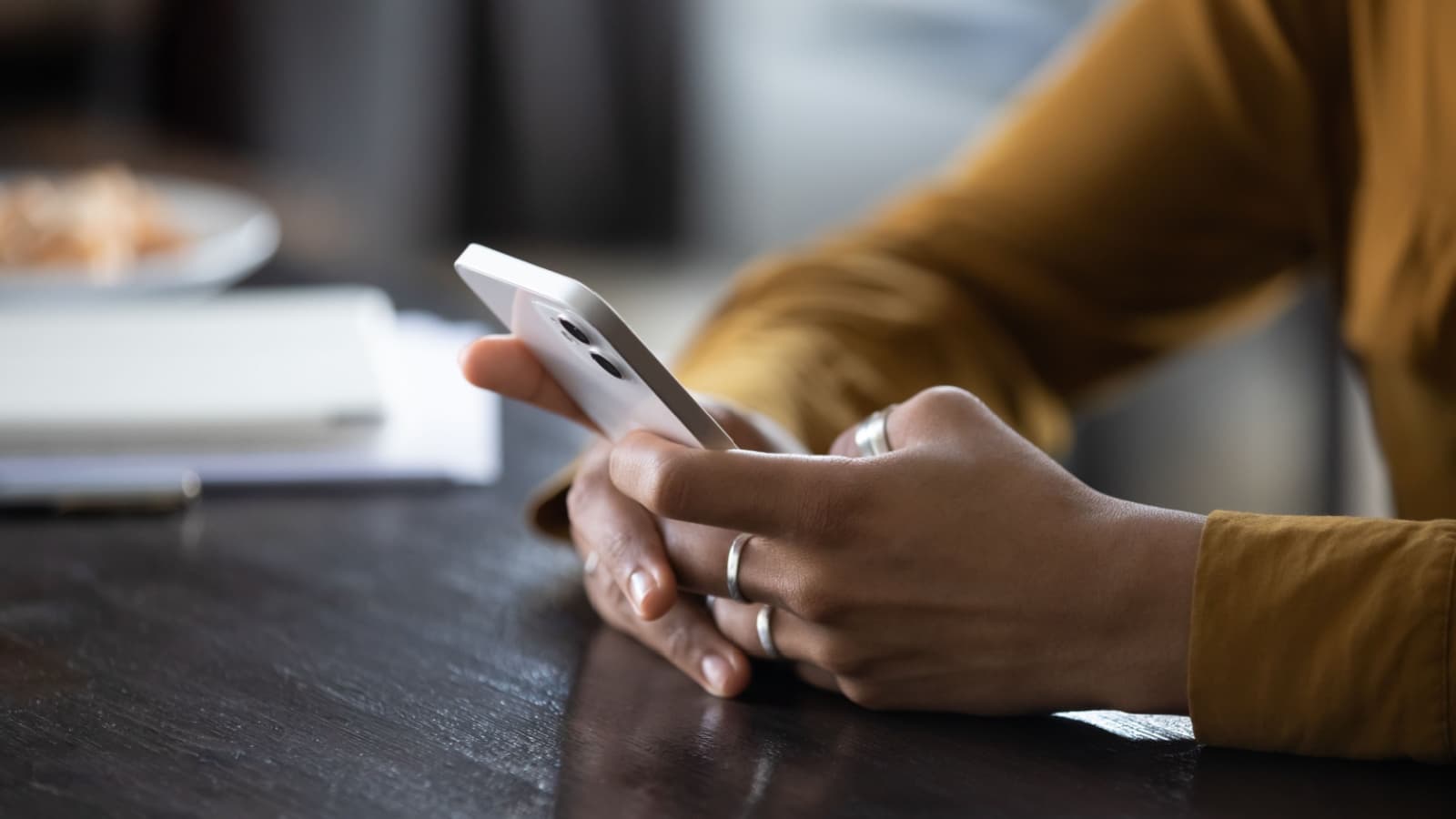 woman's hands shown using phone.