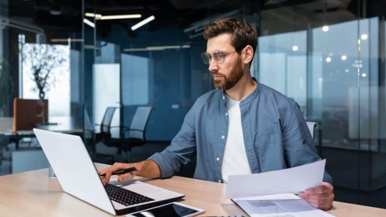 successful man working at computer in office setting.
